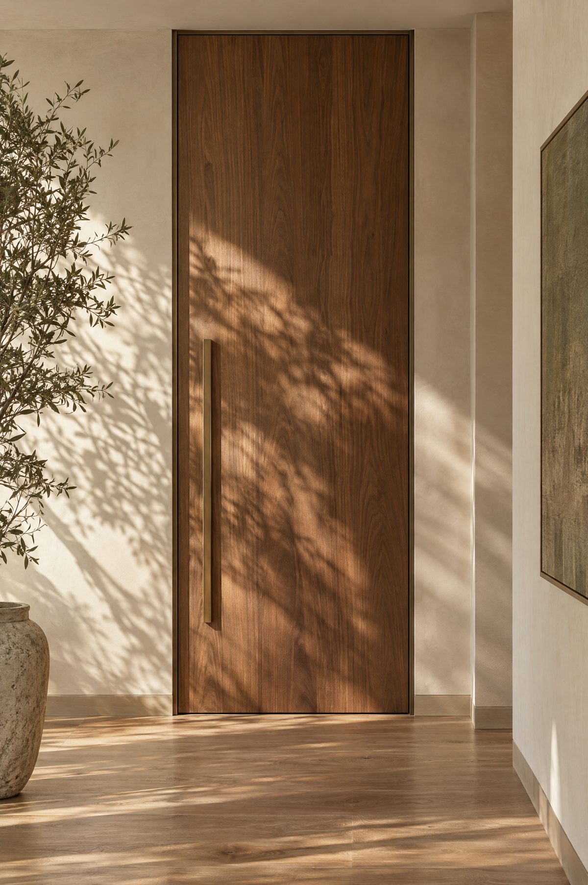 Floor to ceiling walnut door in a slim bronze aluminium frame